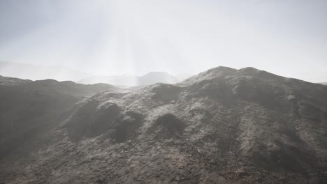 sun rays over mountains in a valley