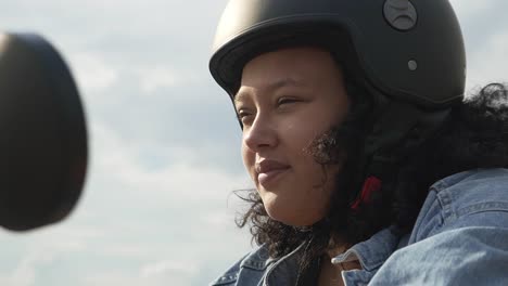 Close-up-and-revealing-shot-of-woman-ready-to-drive-with-her-electric-scooter