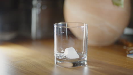 Slow-motion-of-bourbon-being-poured-with-a-couple-of-ice-cubes