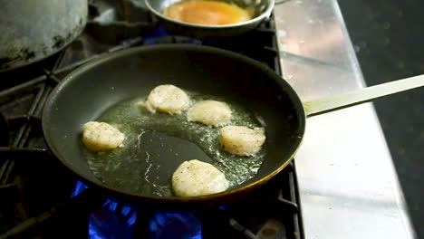 chef cooking and frying in multiple pans