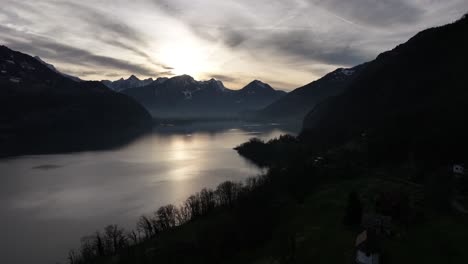 Sunset-over-serene-Walensee-and-Churfirsten-peaks,-Switzerland---aerial