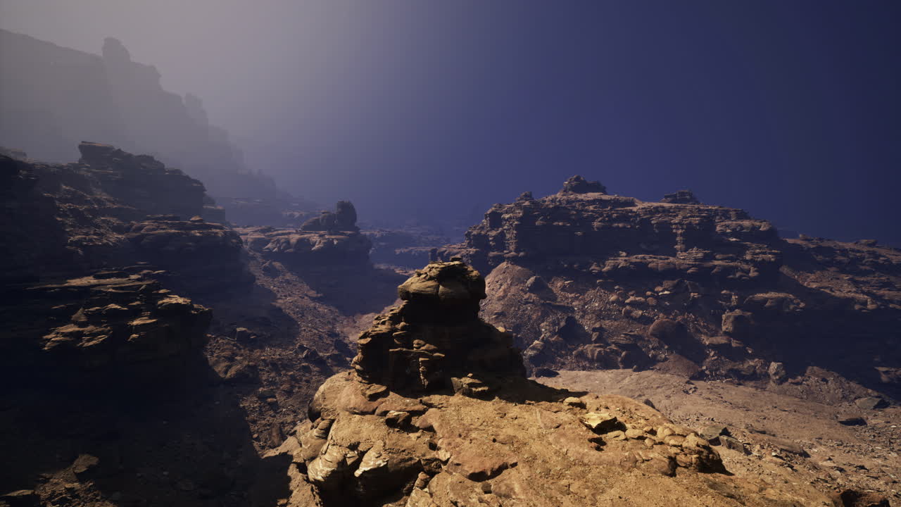 Scenic rocky landscape under a clear blue sky at twilight hour
