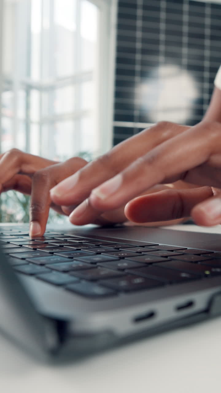 Close-up of Hands Typing on Laptop Keyboard