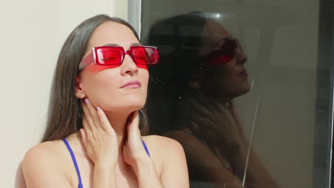 Slow-motion-shot-of-a-woman-in-a-bikini-with-her-hands-on-her-neck