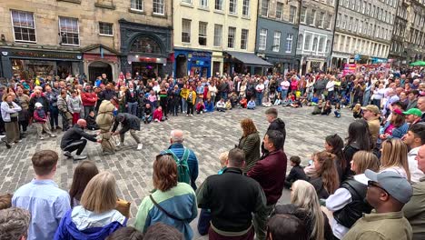 crowd watching a street performance in edinburgh