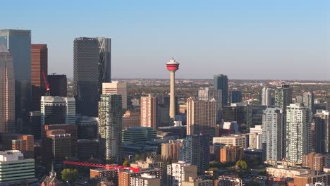 A-aerial-drone-flies-towards-the-Calgary-tower-on-a-beautiful-sunny-day-with-apartment-buildings-and-condos-in-the-foreground