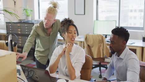 diversas personas de negocios discutiendo con una computadora portátil en la oficina creativa