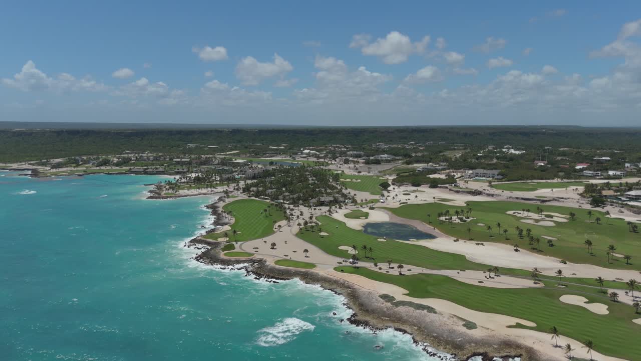 Aerial of dramatic coastline featuring golf holes set along rocky cliffs and ocean waves below