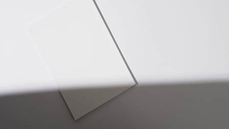 video of shadow over book with blank white pages and copy space on white background