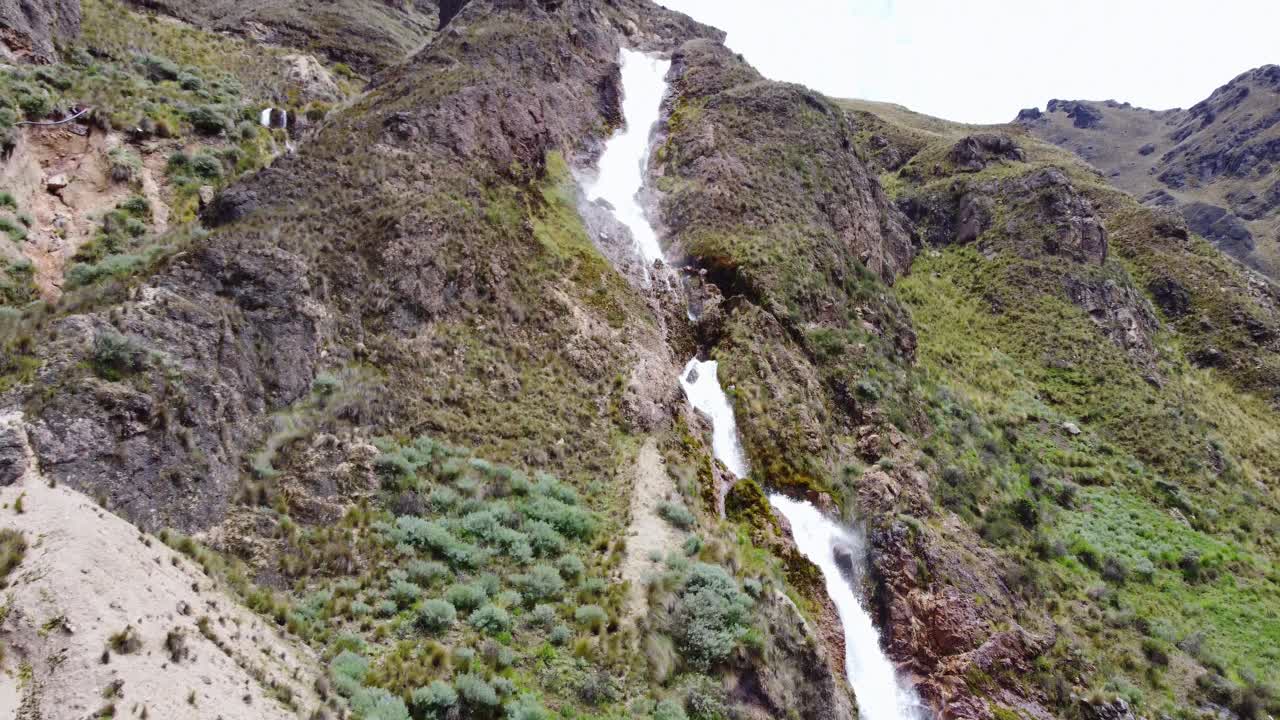 Drone 4k footage of a waterfall. Slowly tilting up from the bottom of the waterwall.