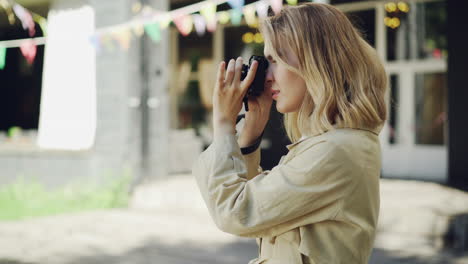 woman taking photograph outdoors