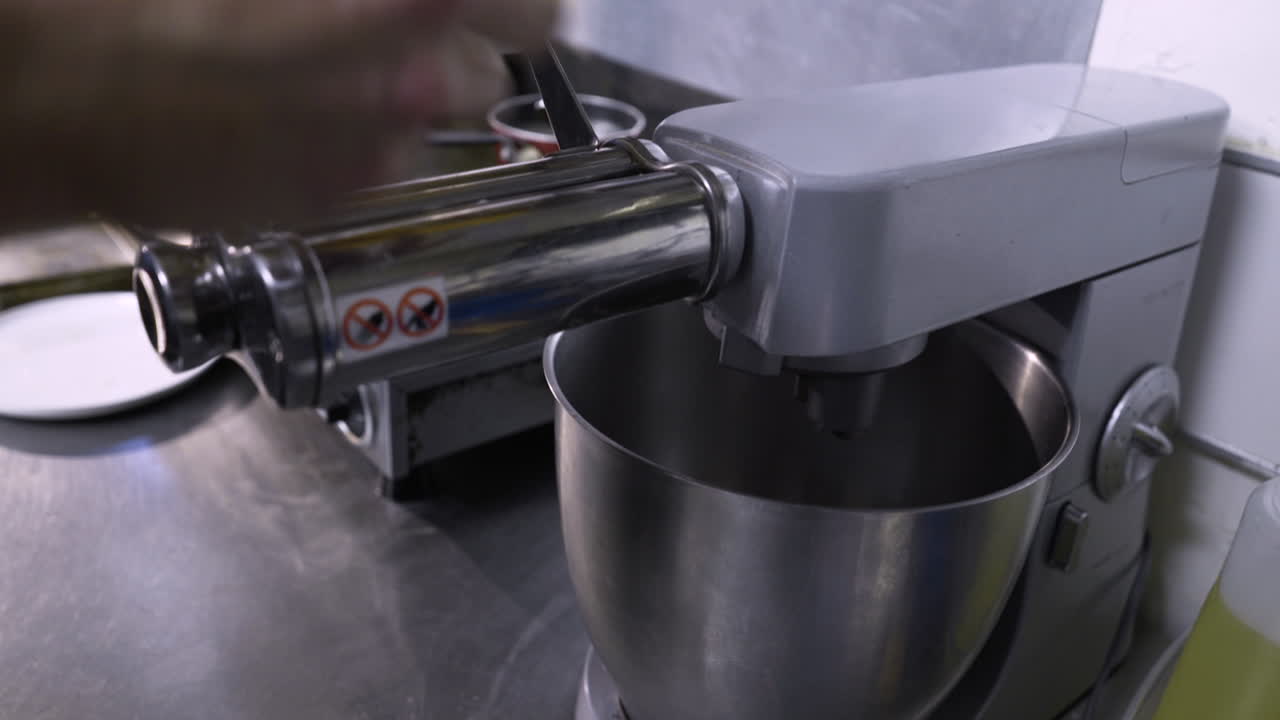 Chef rolling out pasta with a mixer attachment