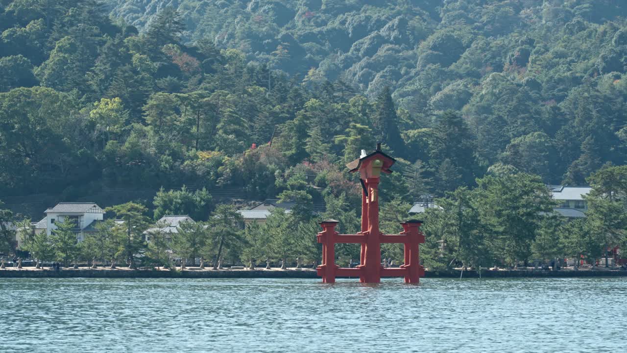 A timeless cultural scene: the torii gate of Itsukushima Shrine surrounded by the natural beauty of Miyajima Island.