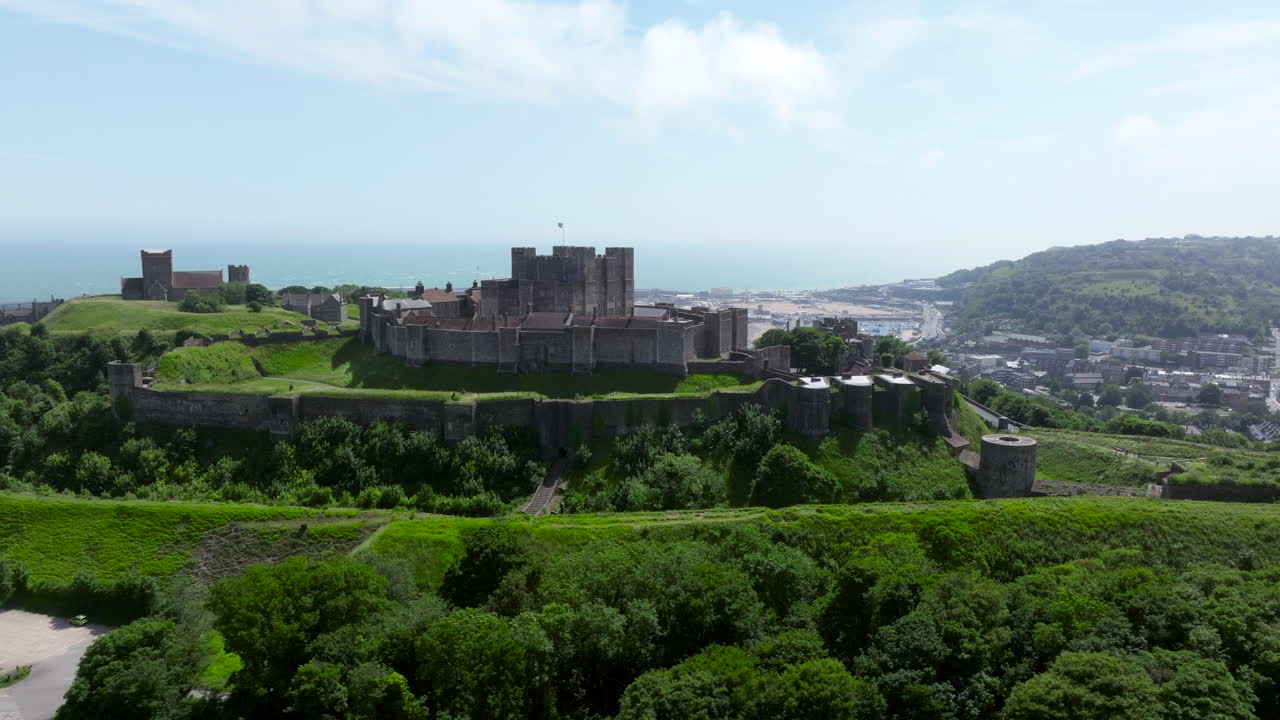 Dover Castle Overlooking The Industrial Port In The Distance in Kent, England, UK. - aerial shot