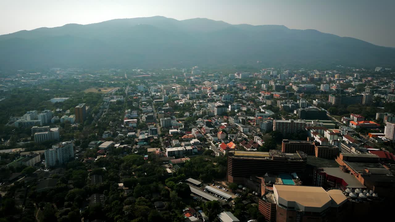 Aerial Scenic Drone Footage of the City of Chiang Mai, Thailand Covered in Smog on a Sunny Day during the Smokey Burning Season