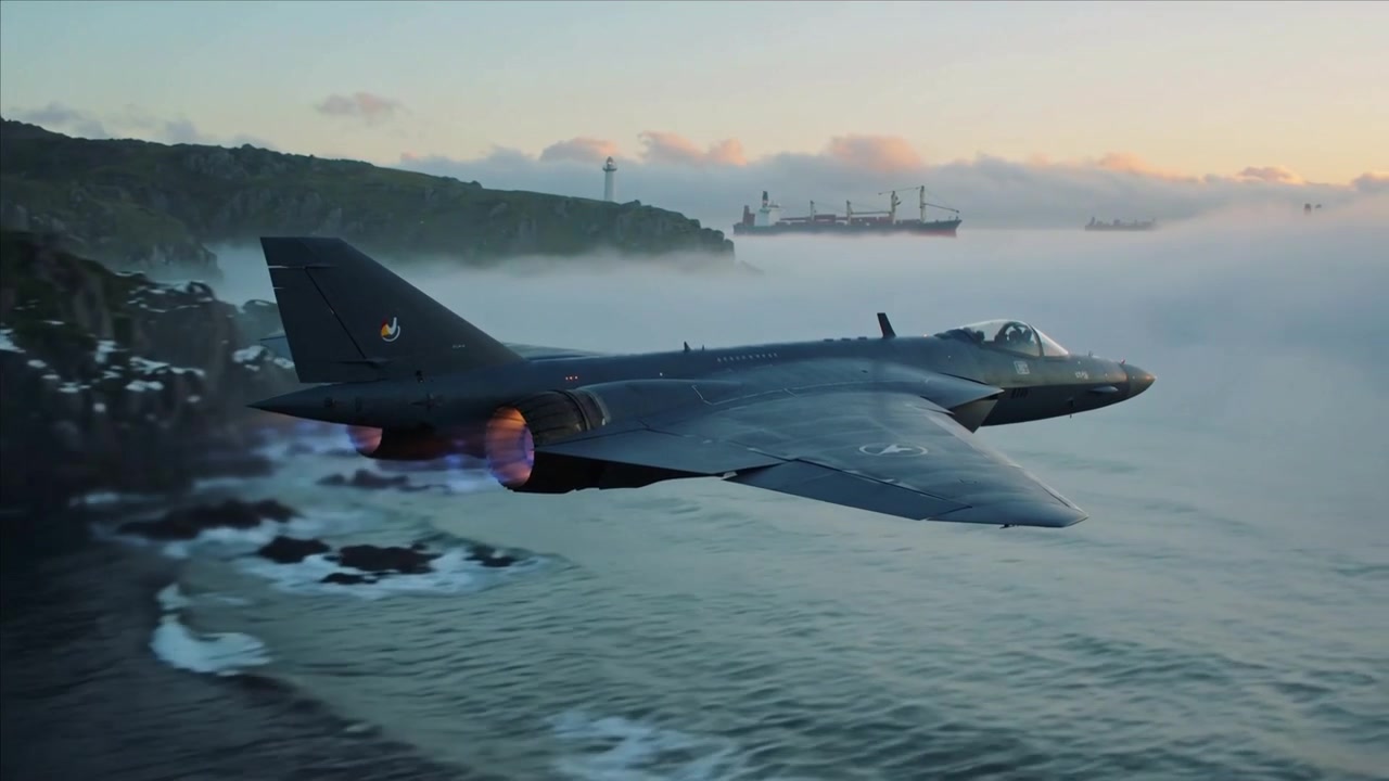 Afterburner firing, dark gray twin engine jet flying low along coastline, tanker