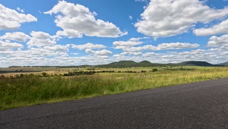 empty highway through vast, open rural landscape