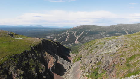 aerial dolly out shot capturing breathtaking view of pristine dromskaran canyon in bastudalen nature reserve, jämtland, sweden