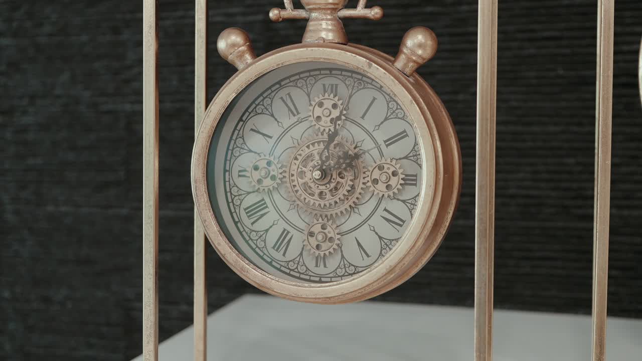 ornate brass timepiece with exposed gears and roman numeral dial