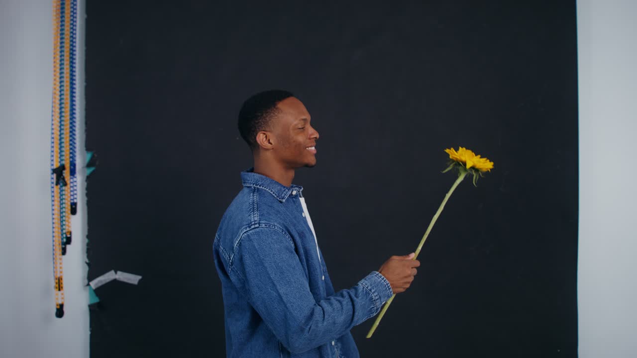 Man smelling a Sunflower