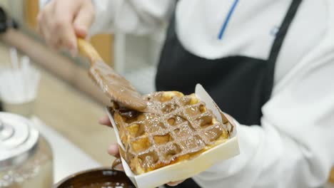 waffles with chocolate sauce being prepared