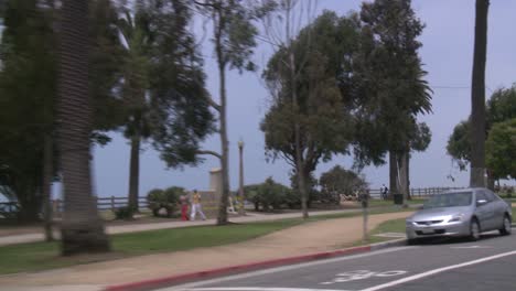 A-Car-Travels-Along-A-Seaside-Street-In-Santa-Monica-California-As-Seen-Through-The-Rear-Window-At-An-Angle-1