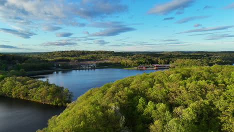 aerial flyover park forest of haverhill, massachusetts in summer. historic winnekenni castl le in background. flight over natural kenoza lake. sunny day in summer