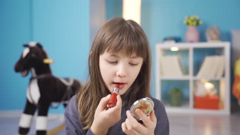 Linda-Niña-Divertida-Haciendo-Maquillaje.-Poner-Lápiz-Labial-En-Los-Labios.