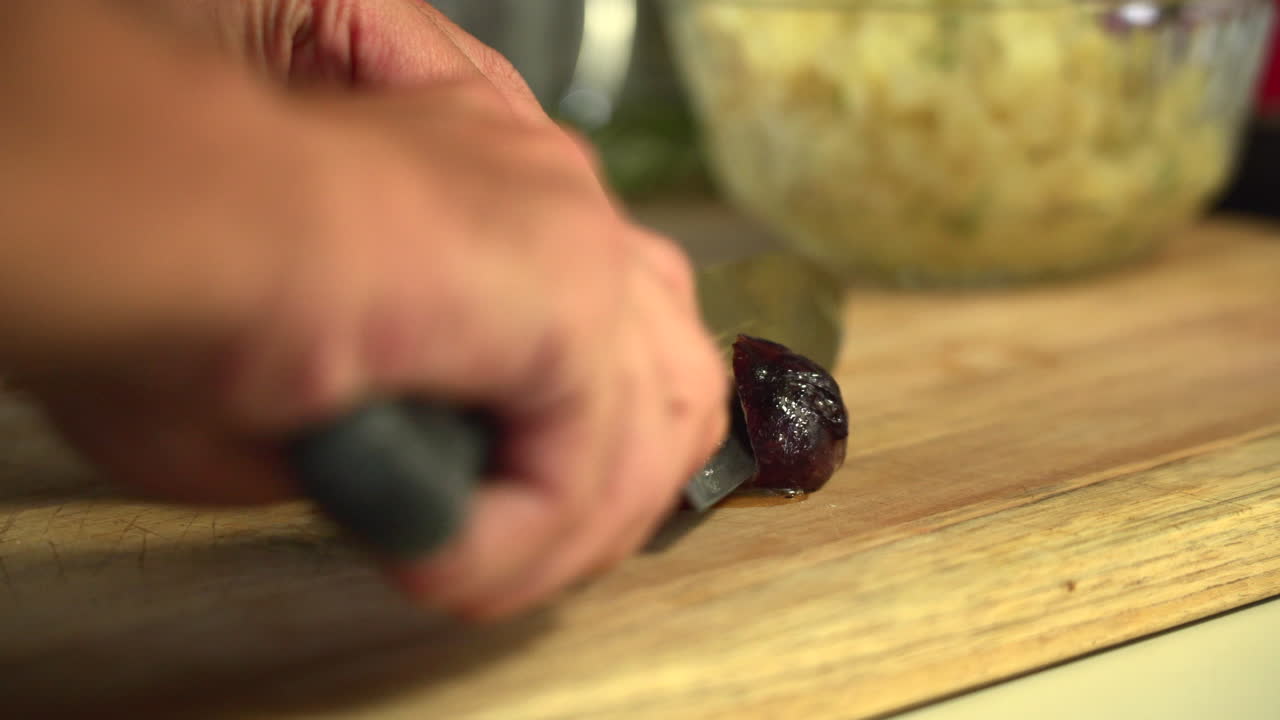 The chef slice a roasted sausage and squeeze the juice out