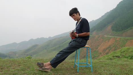 side view of musician playing ukulele outdoors