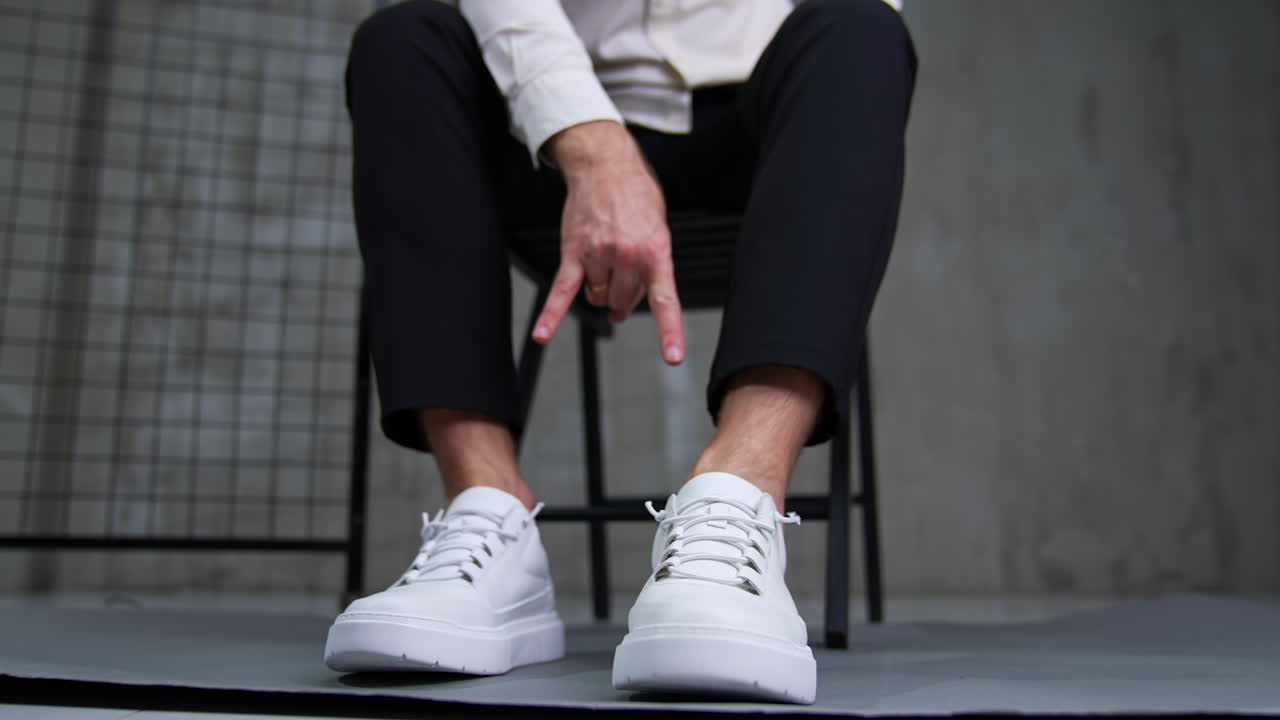Man in White Sneakers and Black Pants