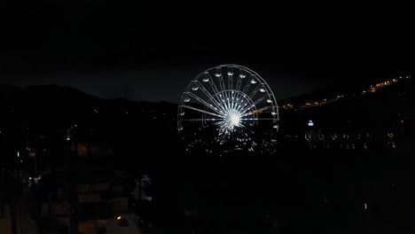 drone aerial reveal ferris wheel in winter - polish city zakopane