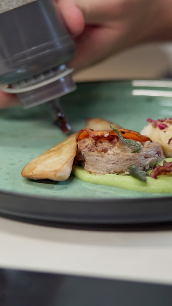 Close-up of Chef Plating Food with Sauce