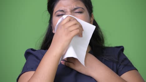 young overweight beautiful indian businesswoman against green background