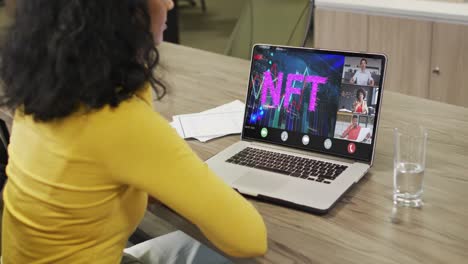 Video-of-african-american-woman-having-nft-video-call-on-laptop-with-diverse-coworkers