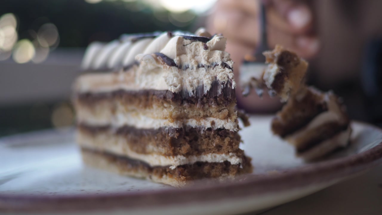 A Fork Cuts into a Delicious Slice of Layered Cake