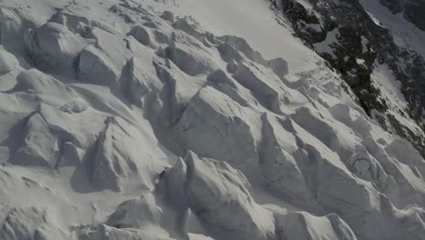 drone close-up shot capturing the lys glacier's icefall in spring, shortly after a windy snowstorm