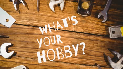 Animation-of-what's-your-hobby-text-in-white,-over-diy-tools-on-wooden-table-top