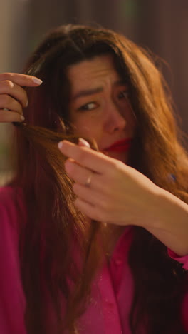 Vertical-Video-Close-Up-Of-Confused-Woman-Sitting-On-Sofa-After-Drinking-Alcohol-At-House-Party-Suffering-With-Hangover