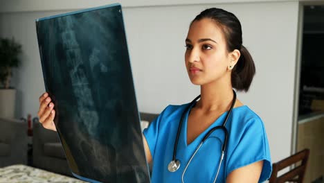 female doctor examining x-ray