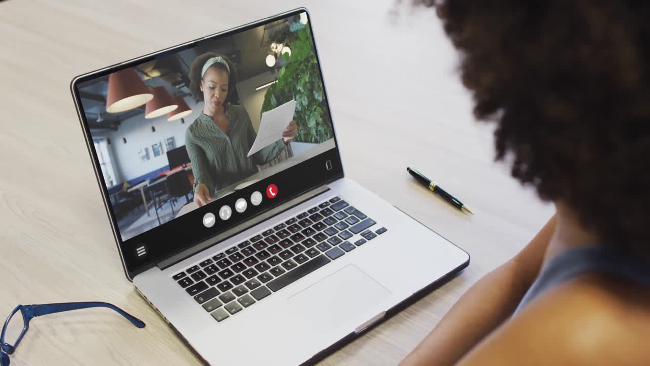 Animation of african american woman having video call on laptop