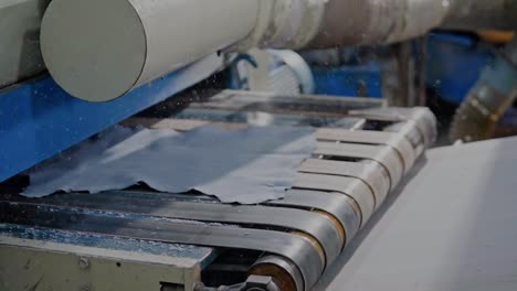 close up shot of products moving on a industrial machine conveyor belt during manufacturing process