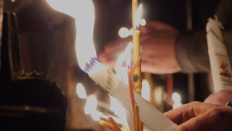 Close-up-of-religious-candles-being-lit-on-Easter-at-the-Church-of-Holy-Sepulchre-in-Jerusalem