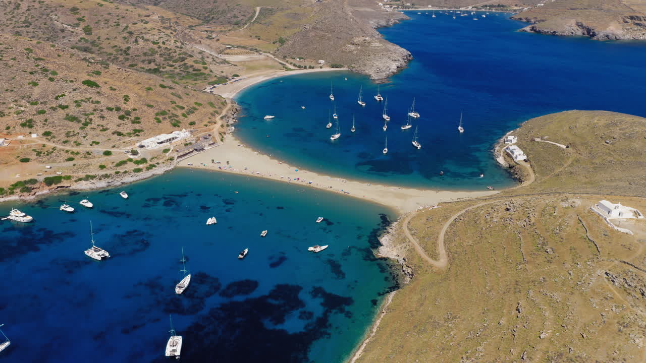 Kolona beach on Kythnos island surrounding rugged mountain landscape, Cyclades, Revealing drone shot
