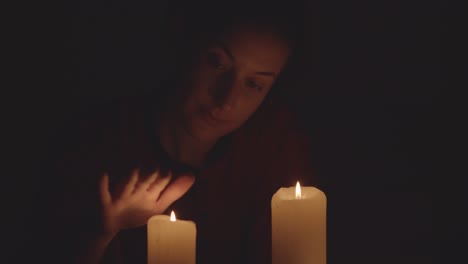 woman and candles in the dark