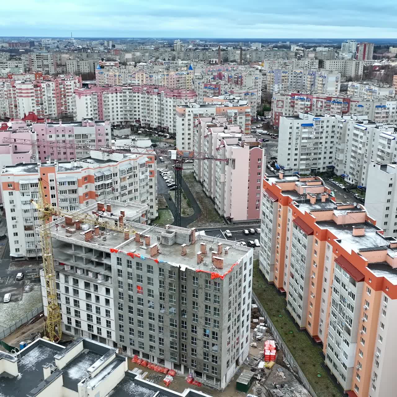New residential city block with beautiful modern buildings. Smooth flight over the already built houses and those in the process of construction