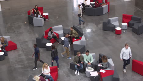 overhead handheld shot of students in university lobby, shot on r3d