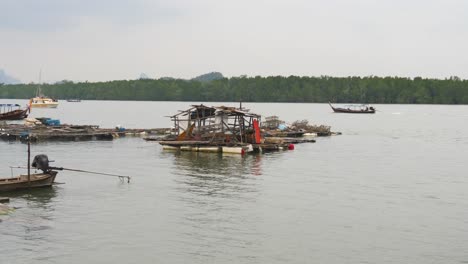 fishing village on koh panyee, thailand with wooden boats and floating homes