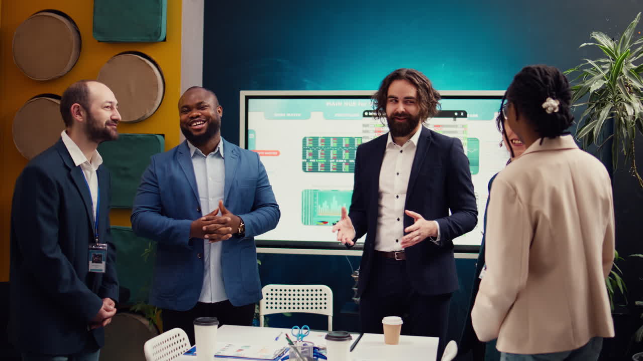 Team of startup employees gathering for a briefing session in boardroom