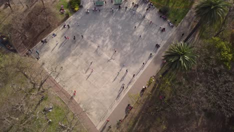 Eine-Dynamische-Luftaufnahme-Von-Oben-Nach-Unten-Von-Verschiedenen-Rollschuhfahrern,-Die-Auf-Dem-Schüsselförmigen-Skatepark-Spielen